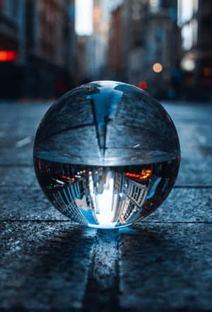 Enchanting Crystal Ball On Wooden Table Wallpaper