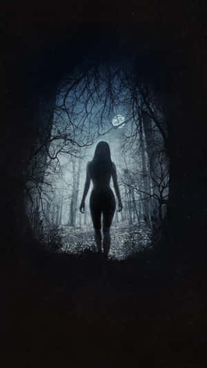 Enchanting Dark Witch Emerging From Shadows Wallpaper