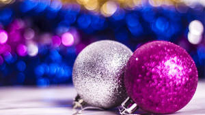 Enchanting Display Of Pink Sparkling Christmas Balls Wallpaper