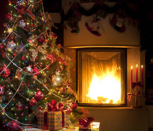 Enchanting Fireplace Christmas Setup On A Cool Winter Night Wallpaper