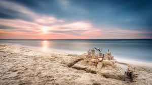 Enchanting Sandcastle Masterpiece On A Serene Beach Wallpaper