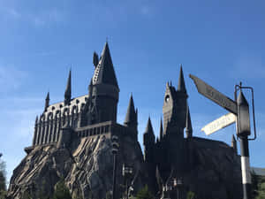 Enchanting Snowy Evening In Hogsmeade Village Wallpaper