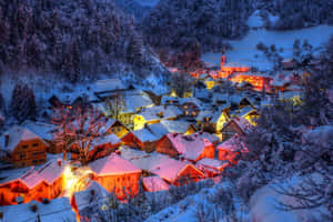 Enchanting Snowy Village In Winter Wonderland Wallpaper