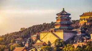 Enchanting Summer Palace Surrounded By Lush Green Trees Wallpaper