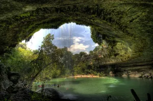 Enchanting_ Waterfall_ Grotto_ Lake_ View Wallpaper