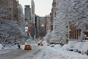 Enchanting Winter Cityscape Blanketed In Snow Wallpaper