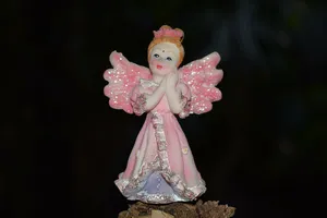 Endearing Angel Figurine With Delicate Pink Wings Wallpaper