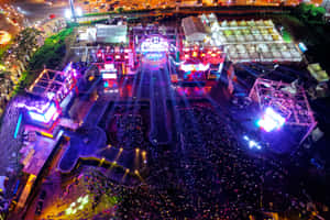 Energetic Crowd At A Music Festival Wallpaper