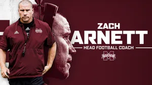 Energetic Football Coach Training On The Field Wallpaper