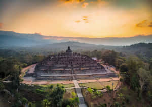 Enigmatic Borobudur Temple Nestled Amidst Mystical Mountain Mist. Wallpaper