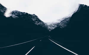 Enigmatic Dark Road Leading Into The Unknown Wallpaper