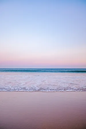 Enjoy A Blissful Day Of Rest And Relaxation At The Tranquil Pastel Beach. Wallpaper