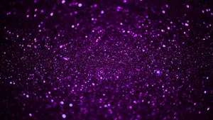 Enjoy A Dazzling Display Of Purple Glitter Wallpaper