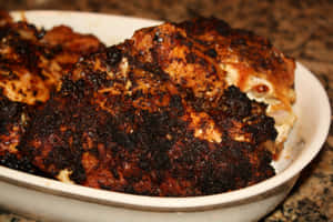 Enjoy A Delectable Meal Of Blackened Chicken Wallpaper