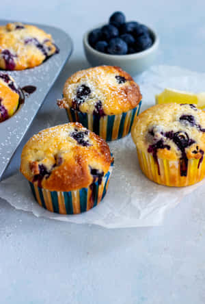 Enjoy A Delicious Handful Of Blueberry Muffins! Wallpaper