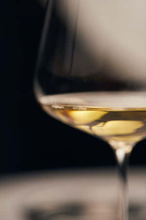 Enjoy A Glass Of White Wine For An Evening Of Relaxation Wallpaper