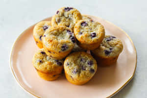 Enjoy A Plate Of Delicious Blueberry Muffins Wallpaper