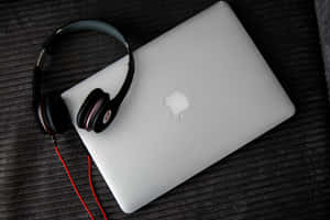 Enjoy Listening To Music On Your Laptop Wallpaper