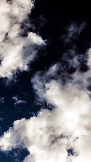 Enjoy The Beauty Of A Sky Full Of Clouds Wallpaper