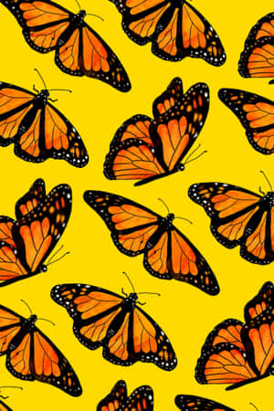 Enjoy The Beauty Of A Vibrant Yellow Butterfly In Nature Wallpaper