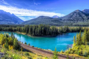 Enjoy The Beauty Of Nature; A Stunning View Of A Mountain Lake Wallpaper