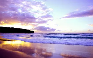 Enjoy The Beauty Of Nature As The Sun Sets Over The Waves Wallpaper