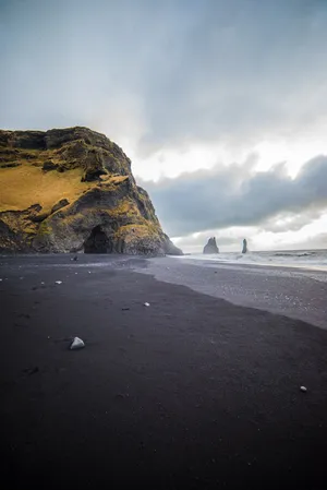 Enjoy The Beauty Of Nature At The Black Sand Beach Wallpaper