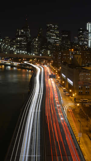 Enjoy The Beauty Of Nature With This Time Lapse Of Clouds Rolling In Over A Lush Green Landscape Wallpaper
