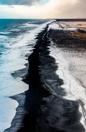 Enjoy The Beauty Of The Dark Sand Beach Wallpaper