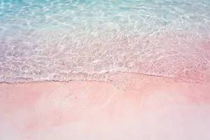 Enjoy The Calming Beauty Of A Pink Beach. Wallpaper