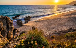 Enjoy The Peaceful Beauty Of A Malibu Beach Sunrise. Wallpaper