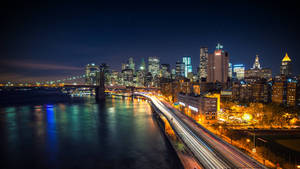 Enjoy The Scenic Beauty Of The City At Night Wallpaper