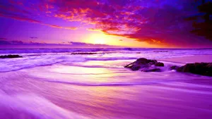 Enjoy The Shades Of Sunset On A Warm Beach Wallpaper