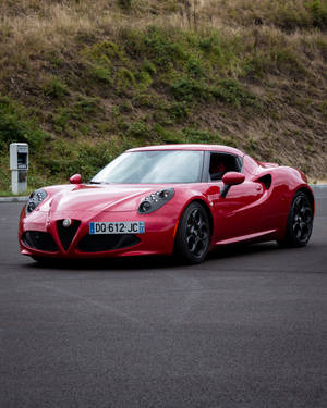 Enjoy The Sleek Style Of The Iconic Red Alfa Romeo 8 C Competizione Wallpaper