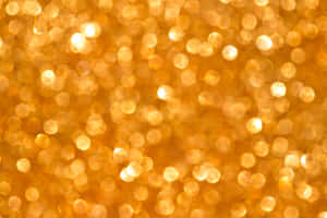 Enjoy The Sparkle And Shine Of Yellow Glitter Wallpaper