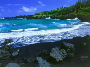 Enjoy The Tranquility Of A Black Sand Beach Wallpaper