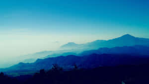 Enjoy The Tranquility Of Blue Mountain Sunrise Wallpaper