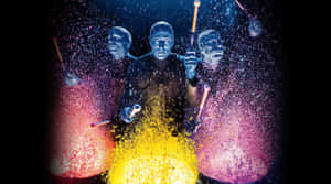 Enjoy The Ultimate Theatrical Experience With Blue Man Group Wallpaper