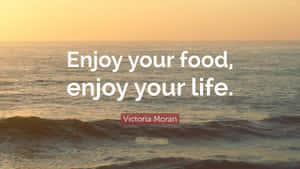 Enjoy Your Food Enjoy Your Life Quote Over Ocean Backdrop Wallpaper