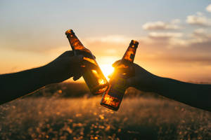 Enjoying A Beer At Sunset Wallpaper