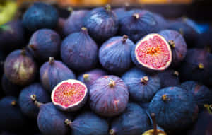 Enjoying A Bunch Of Purple Figs Wallpaper