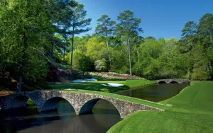 Enjoying A Day Of Golf At Augusta National’s Lush Landscape Wallpaper