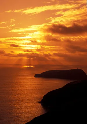 Enjoying A Peaceful Lakeside Sunset Wallpaper