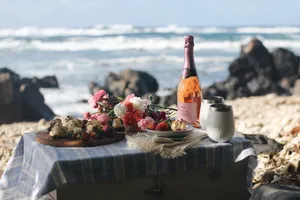 Enjoying A Relaxing Beach Picnic On A Sunny Day Wallpaper