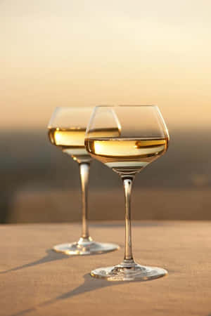 Enjoying The Aroma Of A Delicious White Wine Wallpaper
