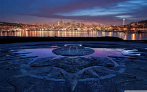 Enjoying The City Lights Of Seattle At Night Wallpaper