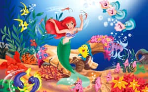 Enjoying The Day Underwater With Her Mermaid Friends Wallpaper