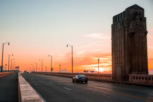 Enjoying The Sunset Over Cleveland's Bridge Wallpaper