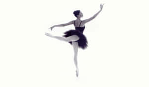 Enthralling Black And White Image Of Ballerina In Arabesque Pose Wallpaper