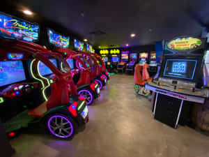 Enthusiastic Gamers Enjoying A Night At The Colorful Arcade Wallpaper